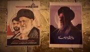 نصب تصاویر رهبر شهید انقلاب و شهید سید محمد موسوی در منطقه بنی‌جمره بحرین
